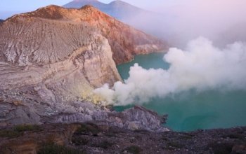 Ijen Crater turquoise acid lake during sunrise Banyuwangi
