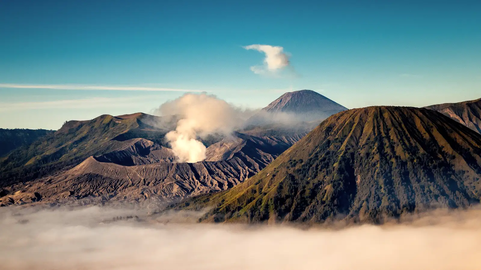 Surreal sunrise over the turquoise acid lake of Ijen Crater