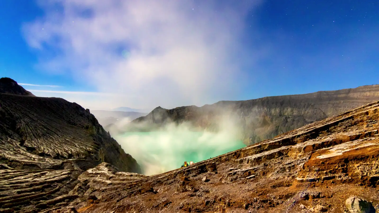 Traveler using a protective pouch for their smartphone while hiking Ijen