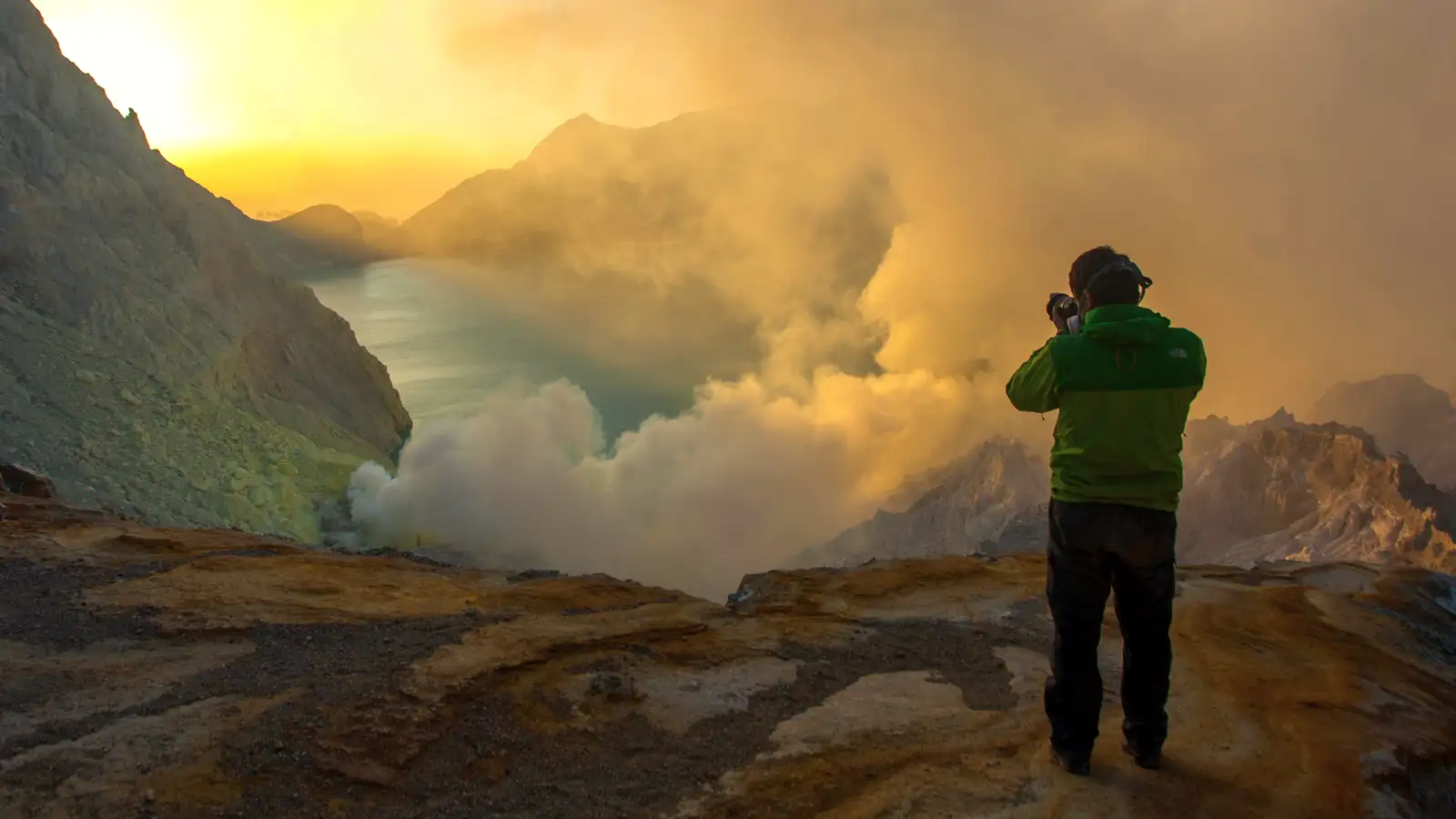 Ijen Crater Tour from Bali Turquoise acidic lake of Ijen Crater at sunrise with volcanic steam