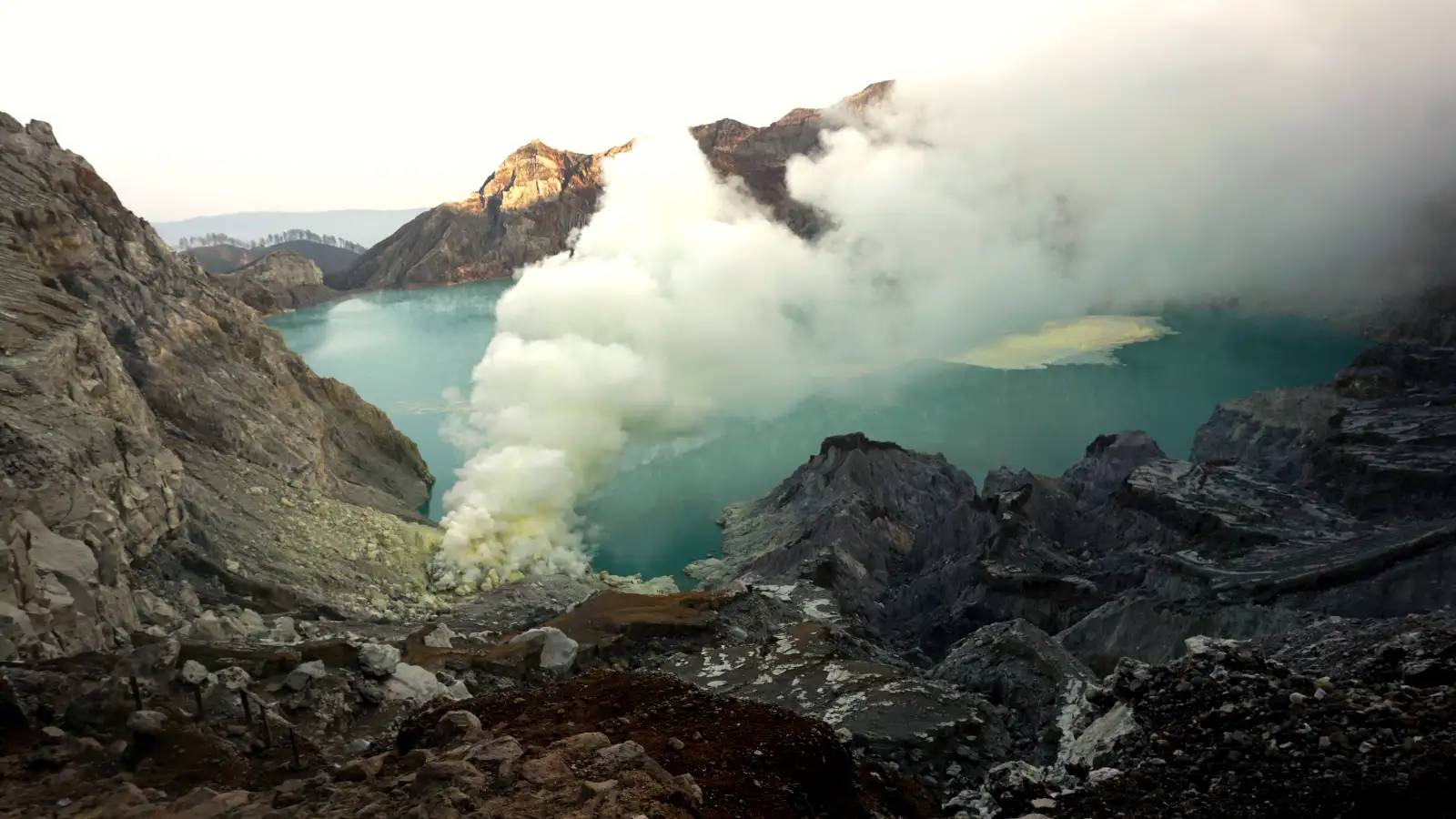 Sulfur miners carrying baskets near the Ijen crater floor