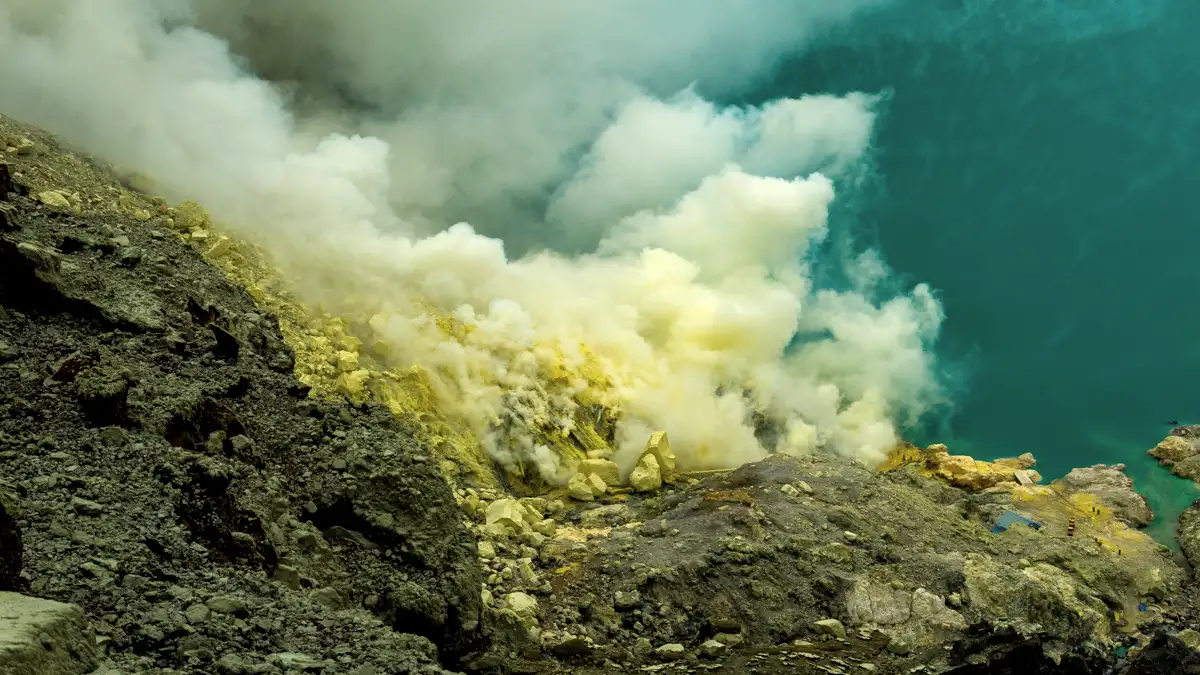 The turquoise acidic lake of the Ijen Volcanic Complex during sunrise