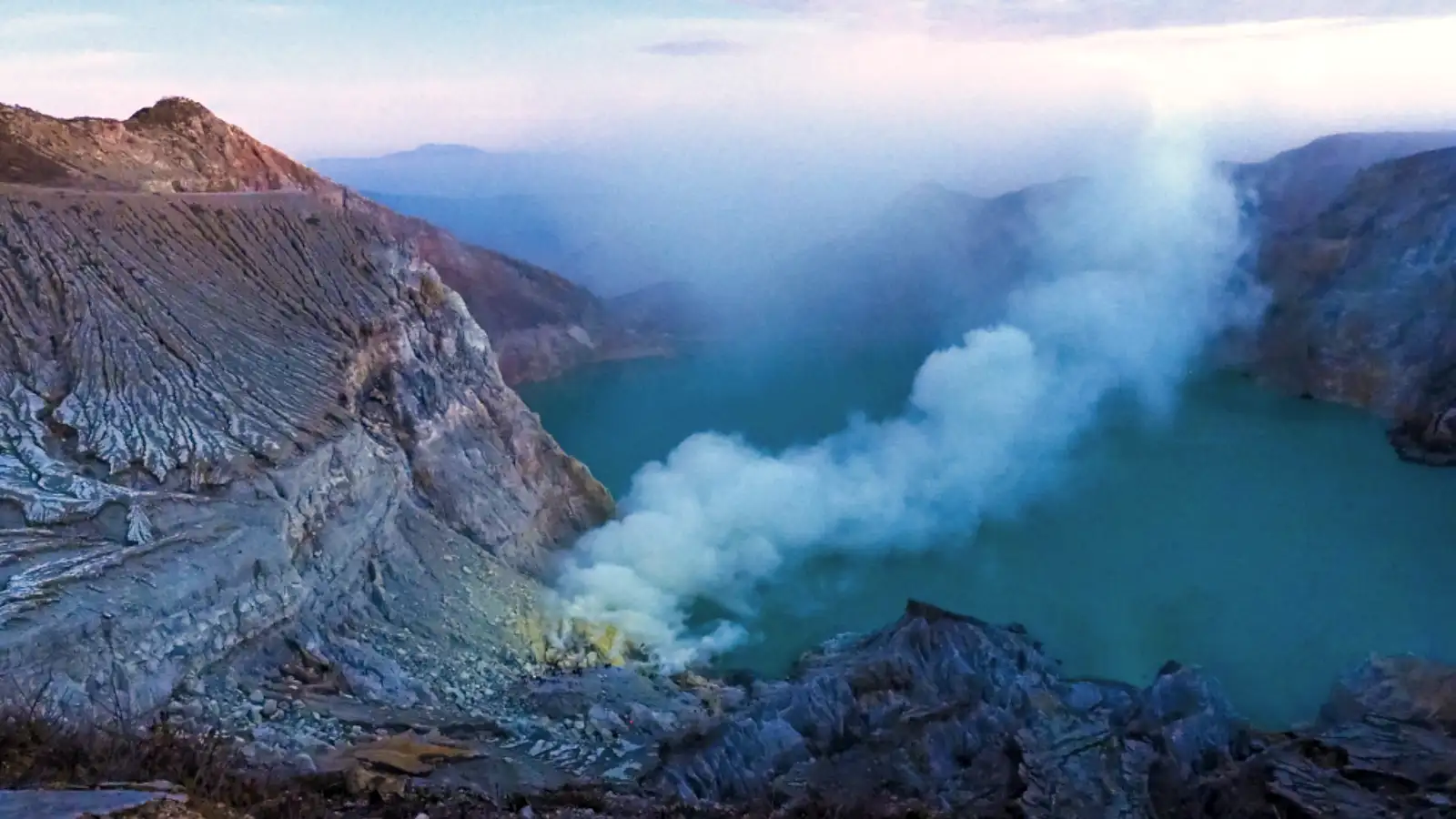 Ijen Volcano Gas Emissions Sulfur gas rising from Ijen Crater lake at sunrise