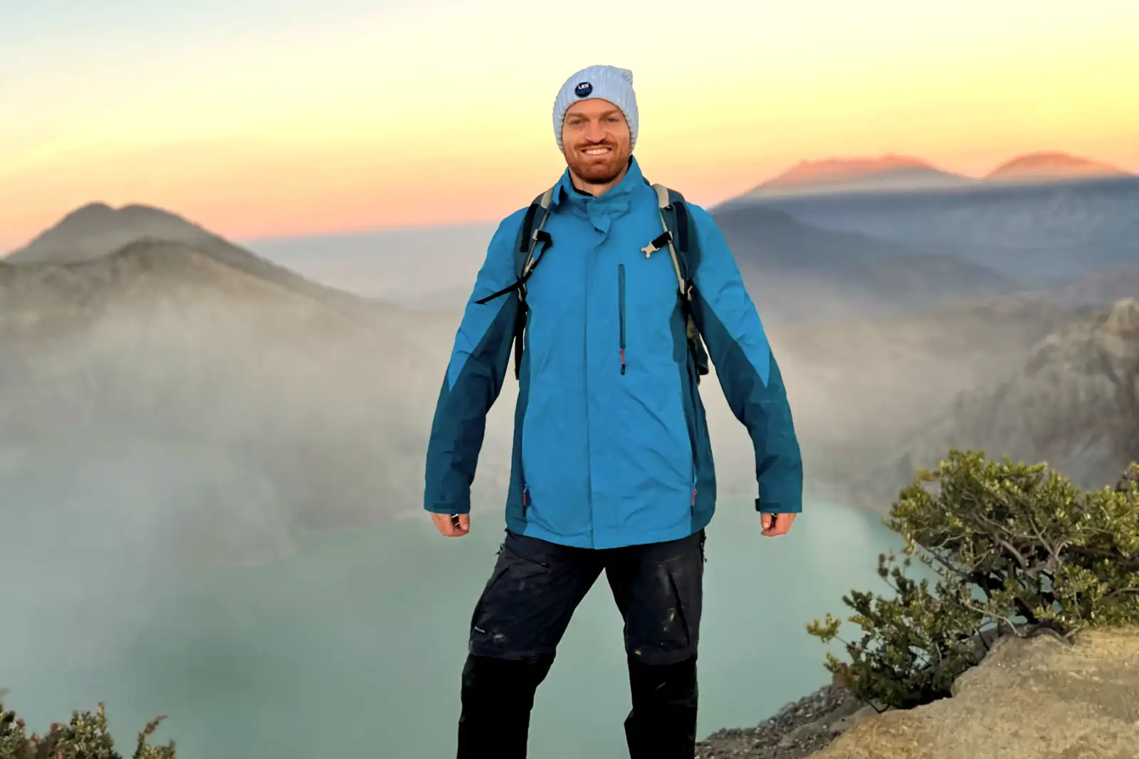 Sunrise over the turquoise acidic lake of Ijen Crater